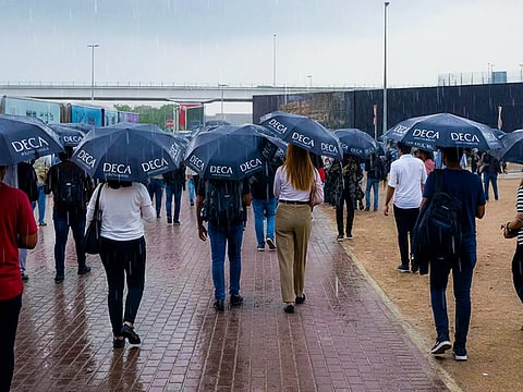 DECA staff hand out umbrellas as rain hits Dubai