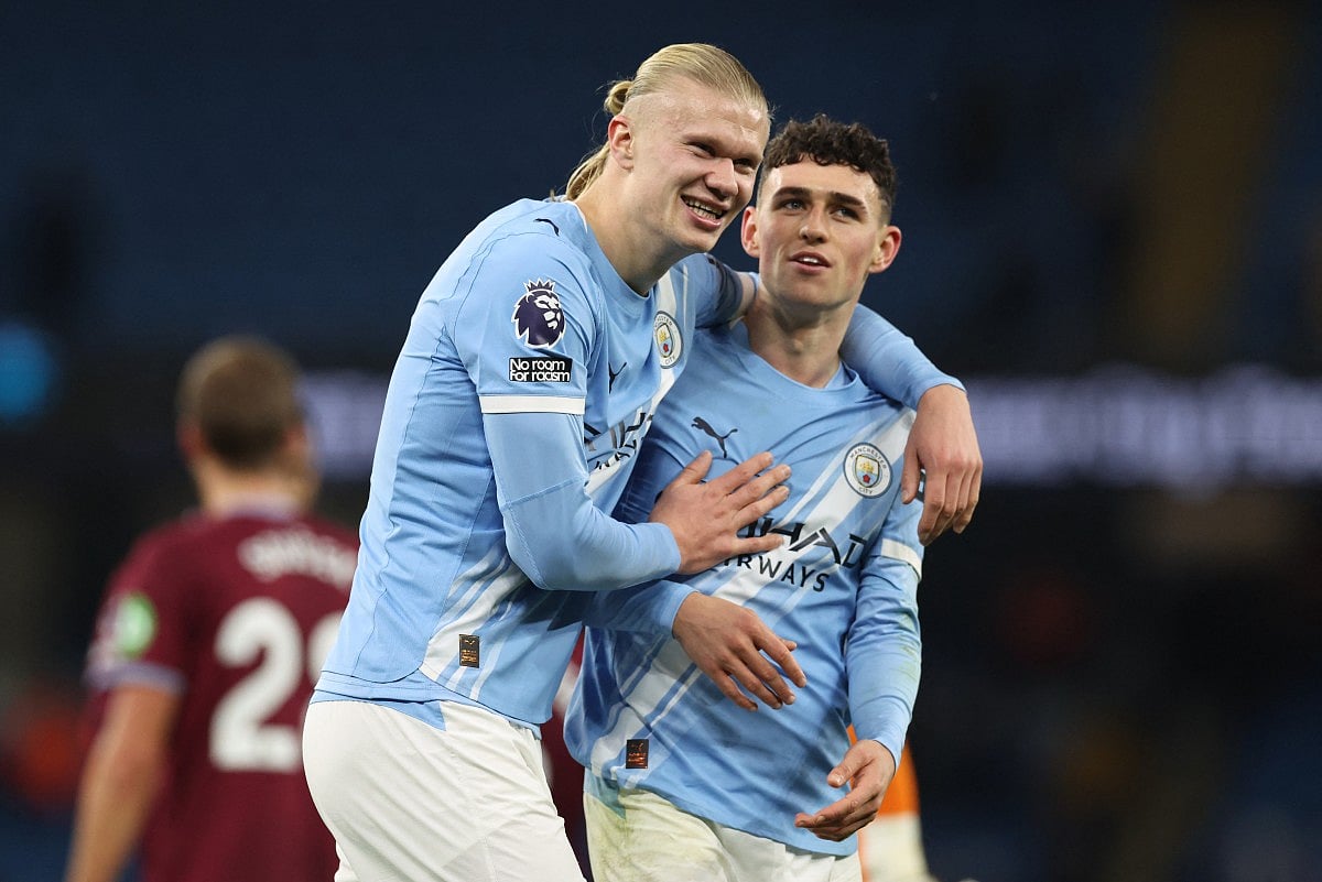Manchester City's Norwegian striker #09 Erling Haaland (L) embraces Manchester City's English midfielder #47 Phil Foden (R) at the end of the English Premier League football match between Manchester City and West Ham United at the Etihad Stadium in Manchester, north west England, on December 20, 2025.