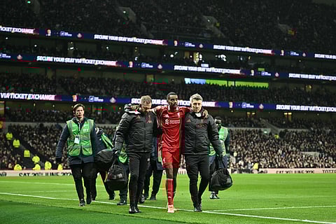 Liverpool's Swedish striker Alexander Isak is helped off the field by medical staff after picking up an injury during the English Premier League football match against Tottenham Hotspur at the Tottenham Hotspur Stadium in London, on December 20, 2025.