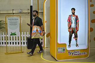 A visitor walks past an installation of Google-developed Gemini’s AI image generator Nano Banana Pro where users can create gaming avatars, during the Bengaluru Comic Con 2025 fest in Bengaluru on December 21, 2025.