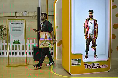 A visitor walks past an installation of Google-developed Gemini’s AI image generator Nano Banana Pro where users can create gaming avatars, during the Bengaluru Comic Con 2025 fest in Bengaluru on December 21, 2025.