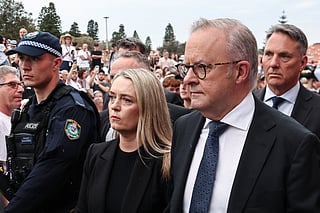 Australia's Prime Minister Anthony Albanese arrives with his wife Jodie Haydon to attend the memorial held for the victims of a shooting at Bondi Beach in Sydney on December 21, 2025.
