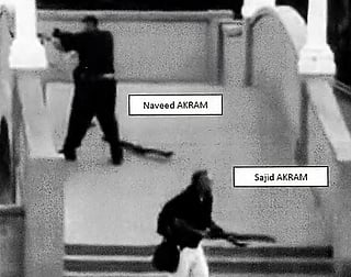 This handout photo from a court exhibit released by the NSW Courts as part of the police facts sheet on December 22, 2025 shows Sajid and Naveed Akram, armed with three firearms, allegedly shooting towards the crowd gathered within Archer Park at Bondi Beach in Sydney on December 14, 2025.