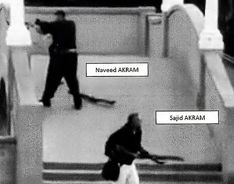 This handout photo from a court exhibit released by the NSW Courts as part of the police facts sheet on December 22, 2025 shows Sajid and Naveed Akram, armed with three firearms, allegedly shooting towards the crowd gathered within Archer Park at Bondi Beach in Sydney on December 14, 2025.