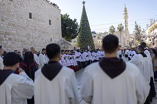 Members of the clergy take part in the yearly Christmas procession led by Latin Patriarch of Jerusalem outside the Church of the Nativity in the Israeli-occupied West Bank city of Bethlehem on December 24, 2025.
