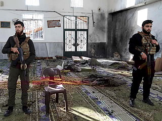Armed security officers cordon off the area following an explosion inside Imam Ali ibn Abi Talib Mosque in the Wadi al-Dahab neighbourhood of Homs on December 26, 2025. 