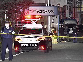 Police officers stand guard at the scene of a stabbing at the Yokohama Rubber Company in Mishima, west of Tokyo, on Friday, December 26, 2025. 