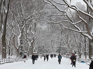 People walk in the snow in Central Park in New York City on December 27, 2025. New York City receieved around 4 inches (10 centimeters) of snow overnight. 