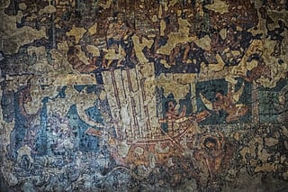 This photograph taken on December 14, 2025 shows a fresco painting of a ship, an inspiration for the Indian Naval Sailing Vessel INSV Kaundinya's design, on the wall of a rock-cut hall at the Ajanta Caves in Maharashtra.