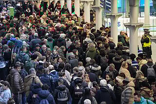 Travellers are pictured at St. Pancras station in London on December 30, 2025, as Eurostar train service between Britain and continental Europe is halted.