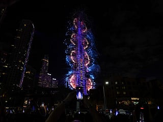 Fireworks light up the sky around the Burj Khalifa Tower, as the UAE welcomes in the New Year, in Dubai on January 1, 2026.