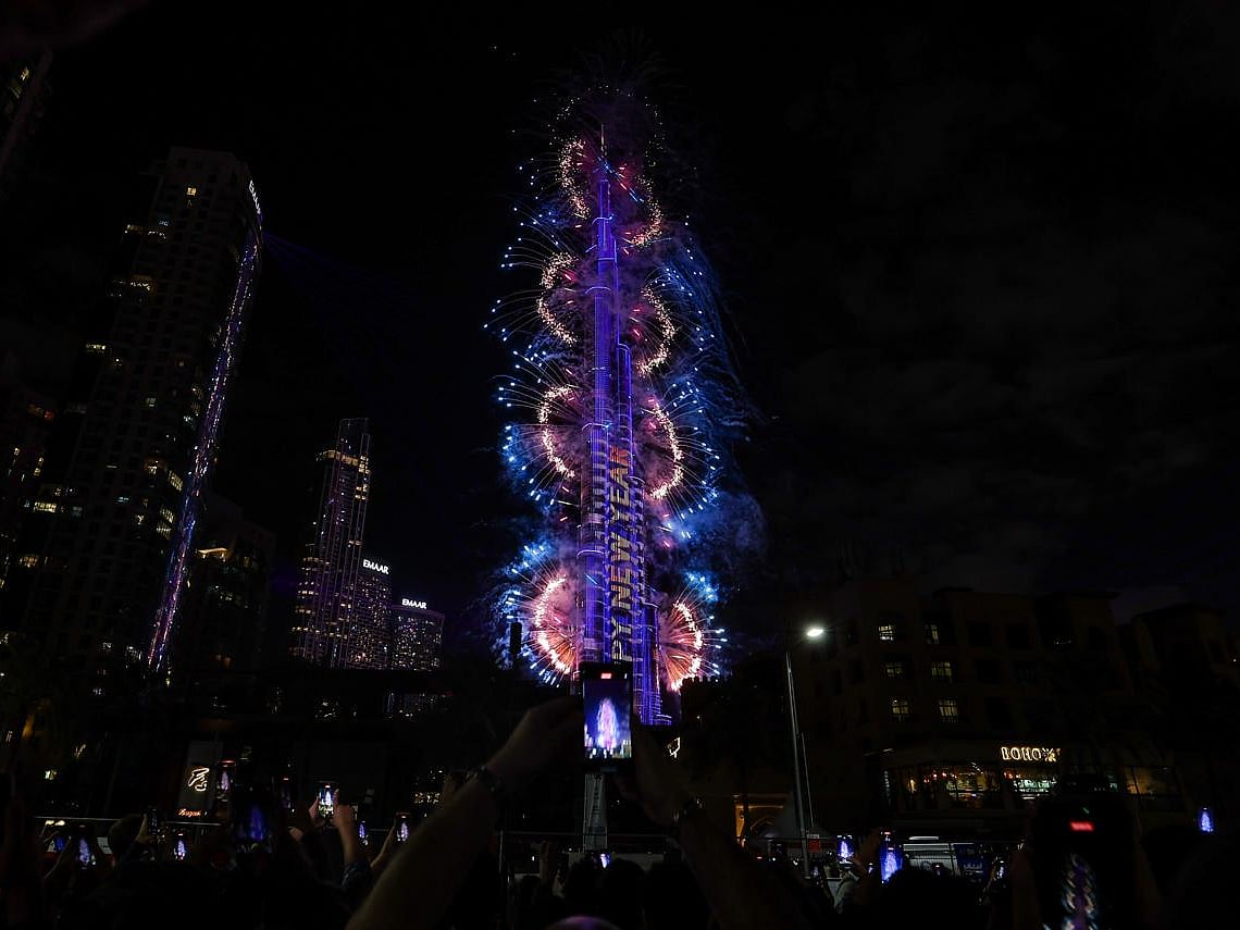 Fireworks light up the sky around the Burj Khalifa Tower, as the UAE welcomes in the New Year, in Dubai on January 1, 2026.