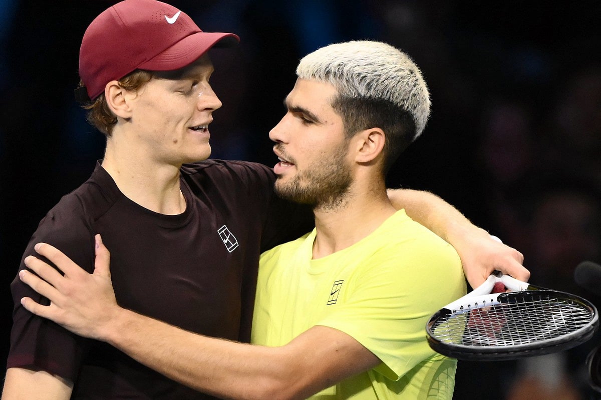 Italy's Jannik Sinner (L) is congratulated by Spain's Carlos Alcaraz at the end of their men's single final match at the ATP Finals tennis tournament, in Turin, on November 16, 2025.