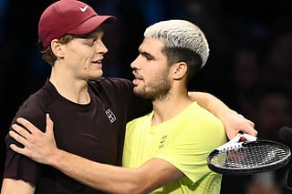 Italy's Jannik Sinner (L) is congratulated by Spain's Carlos Alcaraz at the end of their men's single final match at the ATP Finals tennis tournament, in Turin, on November 16, 2025.