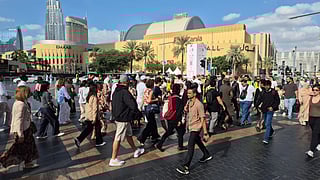 Thousands line walkways as Dubai prepares for Burj Khalifa fireworks.