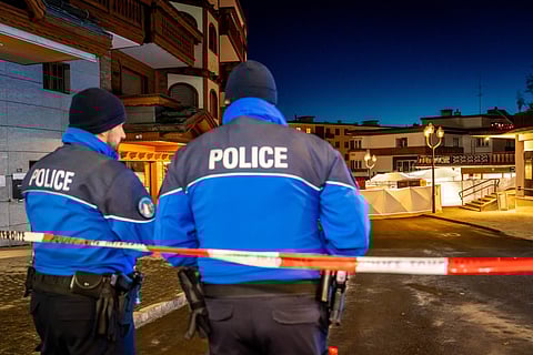 Police control access to the street where a fire ripped through a crowded bar during New Year's Eve celebrations in the Alpine ski resort town of Crans-Montana on January 1, 2026.