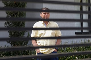 Former Brazilian President Jair Bolsonaro gestures from his residence in Brasilia on September 3, 2025.