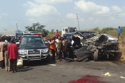 In this photo provided by the Federal Road Safety Corps, people gather at the accident scene of British boxer Anthony Joshua in Lagos, Nigeria, on Monday, Dec. 29, 2025. 