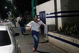 Pedestrians run after explosions and low-flying aircraft were heard in Caracas, Venezuela, Saturday, Jan. 3, 2026. 