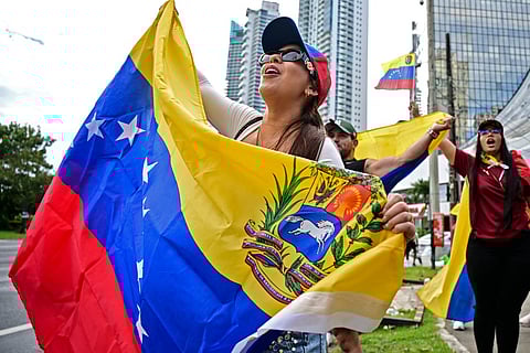 Venezuelans living in Panama celebrate with Venezuelan national flags in Panama City on January 3, 2026, after US forces captured Venezuelan leader Nicolas Maduro.