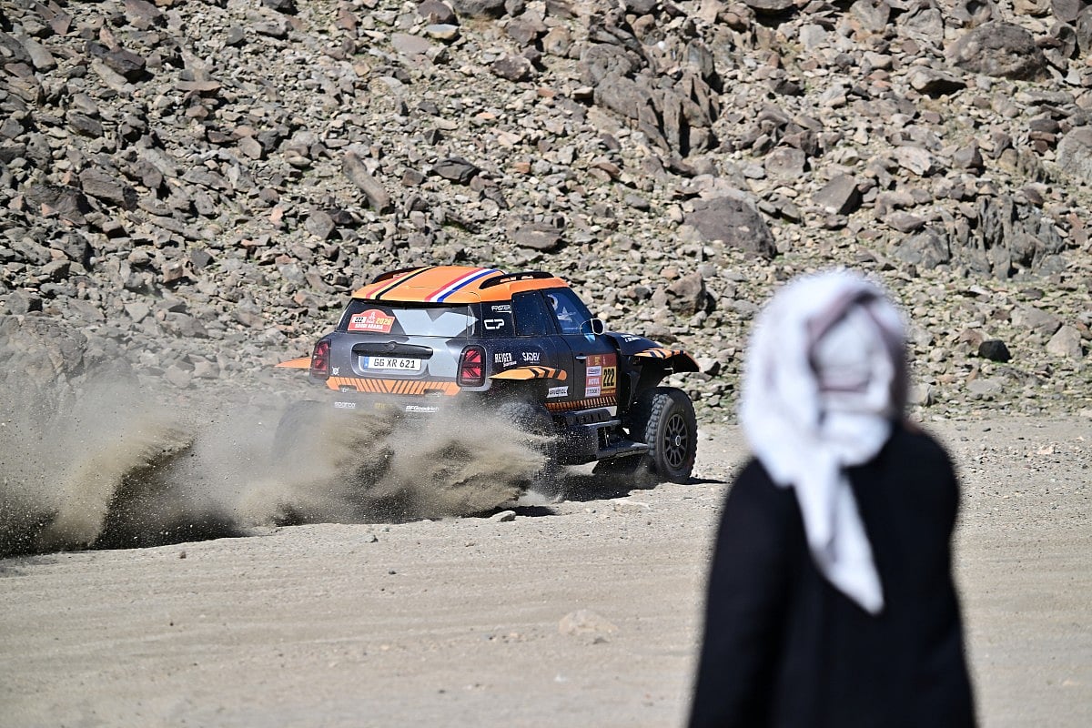 A local watches X-Raid Team Belgian driver Guillaume de Mevius and French co-driver Mathieu Baumel compete in the prologue, which determines the starting line-up for the first stage of the 48th edition of the Dakar Rally 2026, between Yanbu and Yanbu, Saudi Arabia, on January 3, 2026.