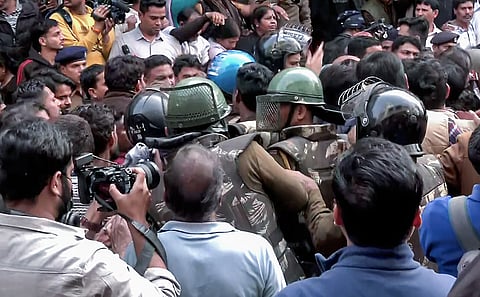 Security forces reach the spot as BJP workers, along with locals, hold a protest against the Congress delegation at the Bhagirathpura area on the water contamination issue, in Indore on Saturday. 
