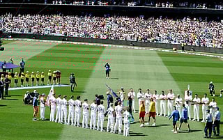 Emergency service personnel and members of the public (C) who responded during a mass shooting at Bondi Beach receive a guard of honour on day one of the fifth Ashes cricket Test match between Australia and England at the Sydney Cricket Ground (SCG) in Sydney on January 4, 2026.