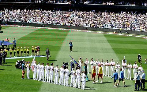 Emergency service personnel and members of the public (C) who responded during a mass shooting at Bondi Beach receive a guard of honour on day one of the fifth Ashes cricket Test match between Australia and England at the Sydney Cricket Ground (SCG) in Sydney on January 4, 2026.