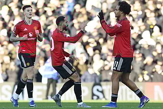 Manchester United's Brazilian striker Matheus Cunha (C) celebrates with Manchester United's Dutch forward Joshua Zirkzee (R) after scoring their first goal to equalise 1-1 during the English Premier League football match against Leeds United at Elland Road in Leeds, northern England on January 4, 2026.