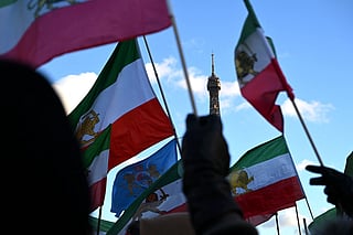 Protesters wave pre-1979 Islamic Revolution flags of Iran during a demonstration against the Iranian regime's crackdown on protests in central Paris, on January 4, 2026.