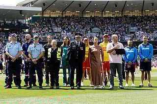 Ahmed al Ahmed (front row R), the man who tackled and disarmed one of the Bondi beach attackers, stands alongside other first responders after receiving a guard of honour for their service, on day one of the fifth Ashes cricket Test match between Australia and England at the Sydney Cricket Ground (SCG) in Sydney on January 4, 2026.
