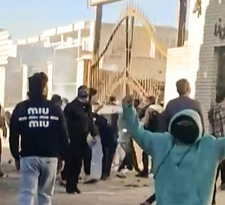 This grab taken on January 2, 2026, from UGC images posted on social media on December 31, 2025, shows protestors attacking a government building in Fasa, in southern Iran.