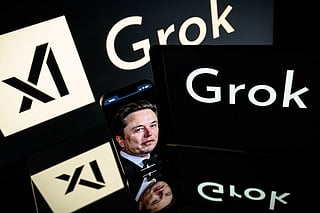 This photograph taken on January 13, 2025 in Toulouse shows screens displaying the logo of Grok, a generative artificial intelligence chatbot developed by xAI, the American company specializing in artificial intelligence and it's founder South African businessman Elon Musk.