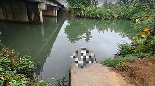 Police manhunt launched after woman's body found in storage box dumped in a river.