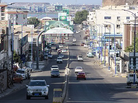 Cars drive through a street in Aden on December 31, 2025. 