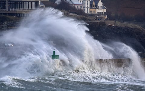 A huge wave crashes on the jetty of the harbor of Le Conquet, western France on January 8, 2026 as storm Goretti is announced to approach France's northern coasts.