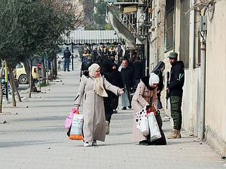 Civilians flee with their belongings after fresh clashes erupted between the Syrian army and the Syrian Democratic Forces in Aleppo, Syria.