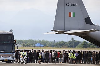 FILE -India nationals, believed to have worked at scam center in Myanmar, board a plane at Thailand's Mae Sot International Airport in Tak, before being sent back to India Nov. 6, 2025. (AP Photo/Sarot Meksophawannakul, File)