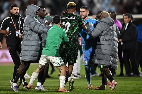 Nigeria's midfielder #18 Raphael Onyedika, Algeria's goalkeeper #23 Luca Zidane and players argue during the Africa Cup of Nations (CAN) quarter-final football match between Algeria and Nigeria at the Grand stadium in Marrakesh on January 10, 2026.