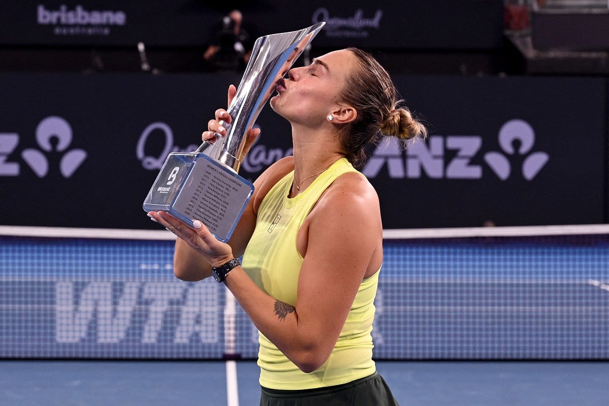 Aryna Sabalenka of Belarus celebrates with the trophy after winning the women's singles final against Marta Kostyuk of Ukraine at the Brisbane International tennis tournament in Brisbane on January 11, 2026.