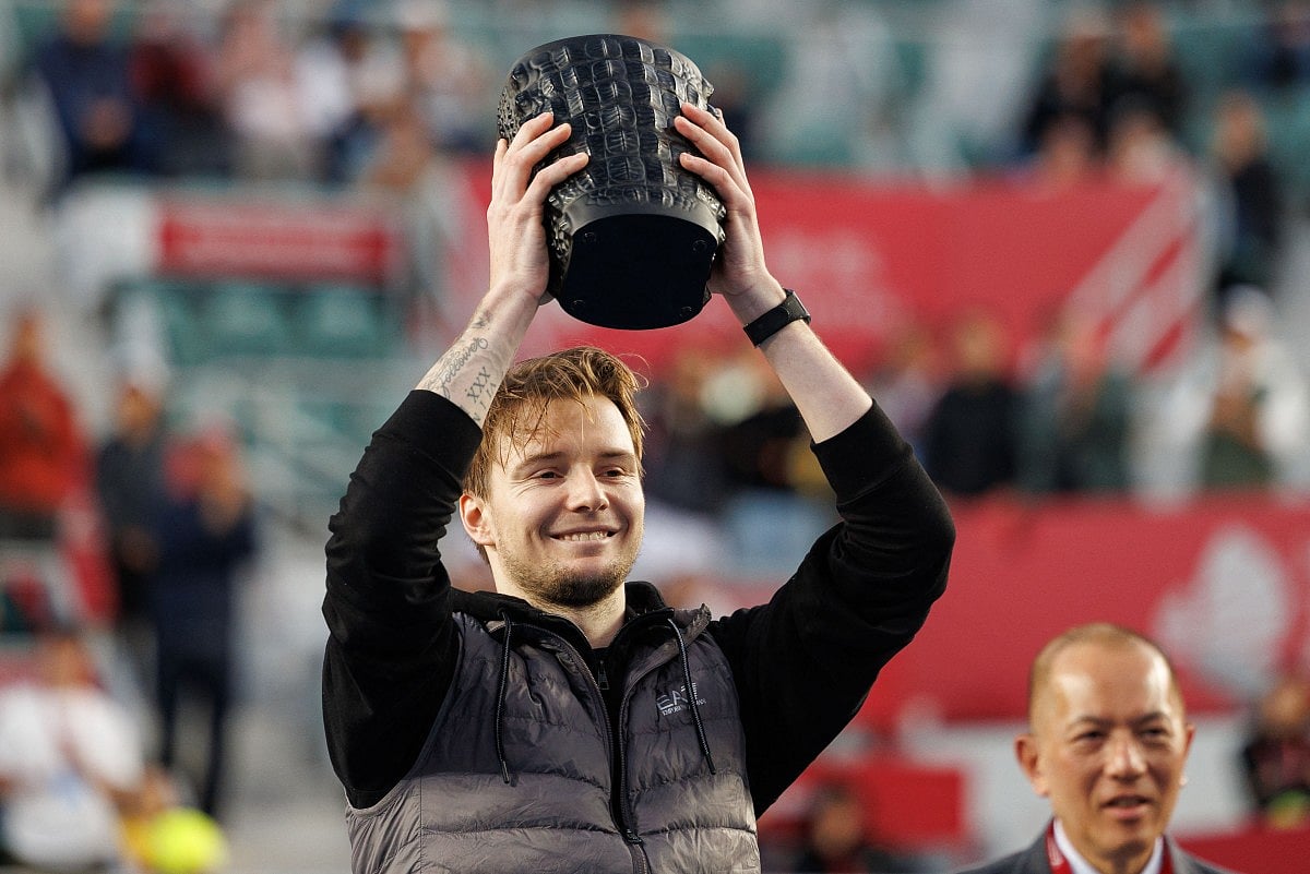 Kazakhstan's Alexander Bublik celebrates with the trophy after his victory against Italy's Lorenzo Musetti during the men's singles final at the Hong Kong Tennis Open in Hong Kong on January 11, 2026.
