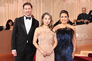 Chris Appelhans, Maggie Kang and Michelle Wong attend the 83rd Annual Golden Globe Awards at The Beverly Hilton on January 11, 2026 in Beverly Hills, California.