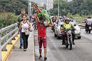 Pedestrians cross the border from Venezuela to Villa del Rosario, Colombia, Monday, Jan. 5, 2026, two days after U.S. forces captured and removed Venezuelan President Nicolas Maduro. (AP Photo/Santiago Saldarriaga)