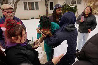 A family member, center, reacts after federal immigration officers make an arrest Sunday, January 11, 2026, in Minneapolis. 