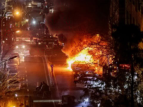 Cars burn during protests over the collapse of the currency’s value in Tehran, Iran. (Photo/Reuters)