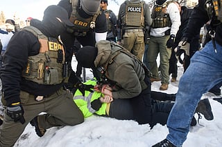 ICE and other federal officers detain a person during protests as ICE operates in a residential neighborhood in Minneapolis, Minnesota, on January 13, 2026.