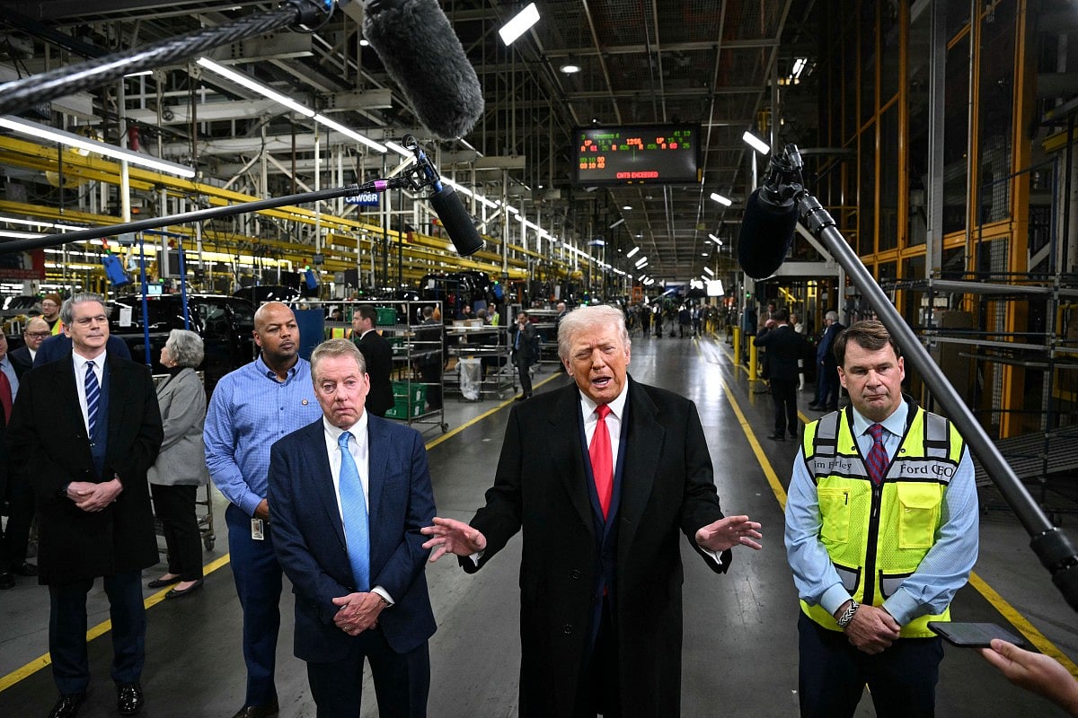 US President Donald Trump speaks alongside Ford executive chairman Bill Ford (3rd L), Ford CEO Jim farley, Treasury Secretary Scott Bessent (L) and plant manager Corey Williams as he tours Ford Motor Company's River Rouge complex in Dearborn, Michigan, on January 13, 2026.