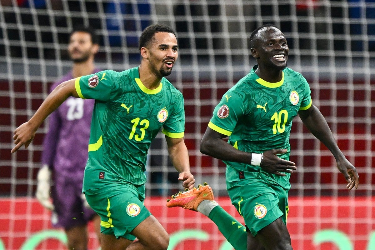 Senegal's forward #10 Sadio Mane celebrates his goal with Senegal's forward #13 Iliman Ndiaye during the Africa Cup of Nations (CAN) semi-final football match between Senegal and Egypt at the Grand stadium in Tangiers on January 14, 2026.