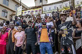 Young voters celebrate as ballots for their preferred candidates are counted after the close of polls at a public ground used as a polling station in Kampala on January 15, 2026, during Uganda’s 2026 general elections.