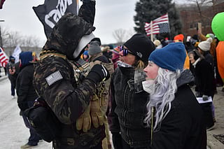Protesters (R) are confronted by an ICE supporter during a demonstration outside the Bishop Whipple Federal Building in Minneapolis, Minnesota, on January 15, 2026.